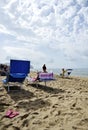 Women on the beach relaxing by reading gossip magazines.